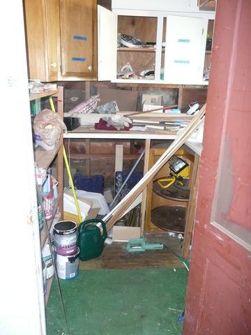 Cluttered storage room with open wooden cabinets