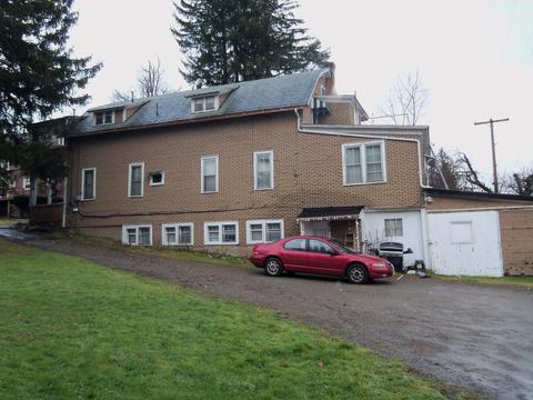 Two-story brick building with multiple windows